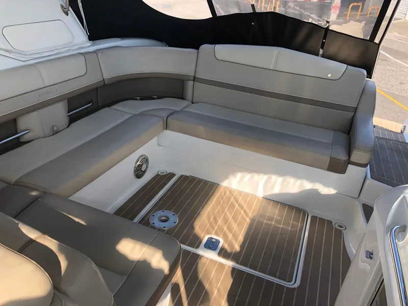 Slide: The Image of 2013 Formula 350 Sun Sport boat interior with beige seating and wood-patterned flooring. - 8