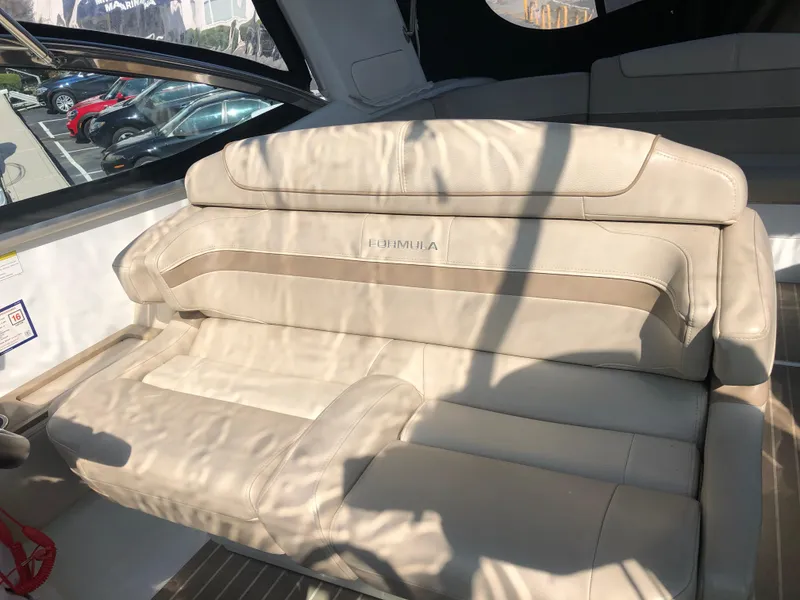Slide: The Image of 2013 Formula 350 Sun Sport boat interior with beige leather seating. - 9