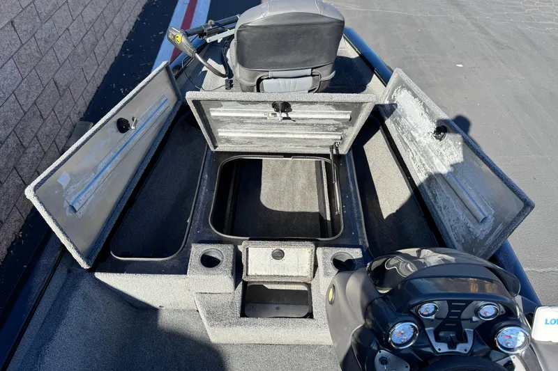 Slide: The Image of 2019 Tracker Pro Team 175 boat interior with open storage compartments and steering console. - 12