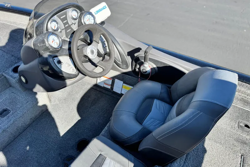 Slide: The Image of 2019 Tracker Pro Team 175 boat cockpit with steering wheel and gauges. - 17