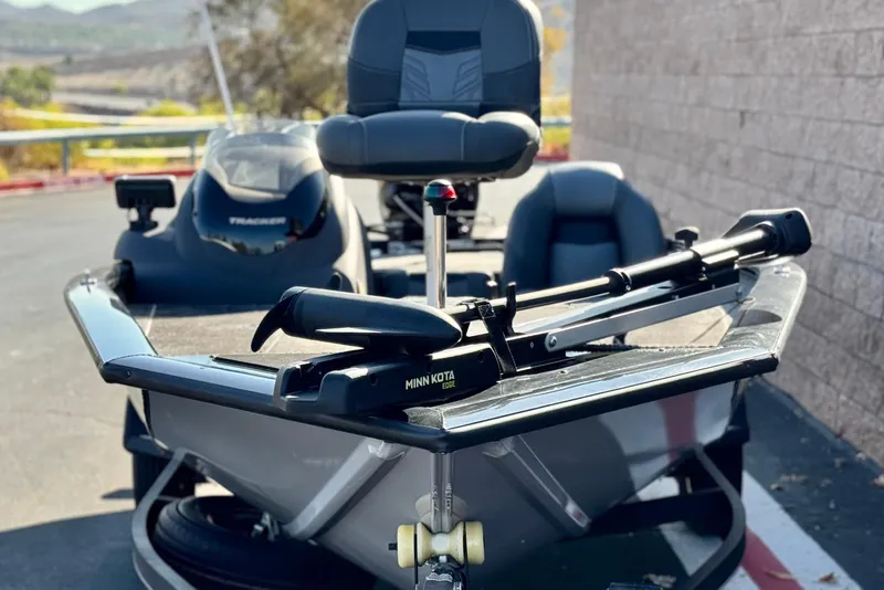 Slide: The Image of 2019 Tracker Pro Team 175 boat with Minn Kota trolling motor, parked outdoors. - 2
