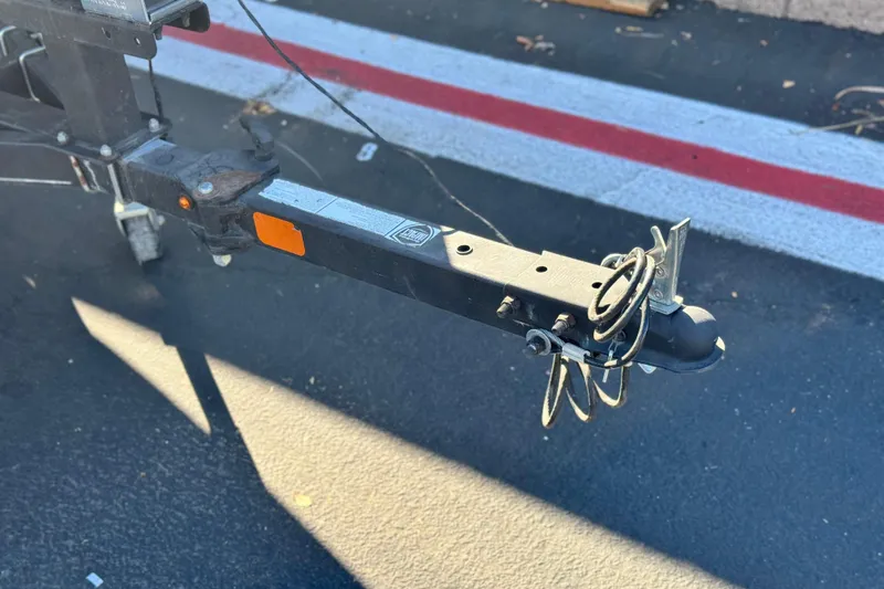 Slide: The Image of Trailer hitch of a 2019 Tracker Pro Team 175 boat on asphalt. - 21