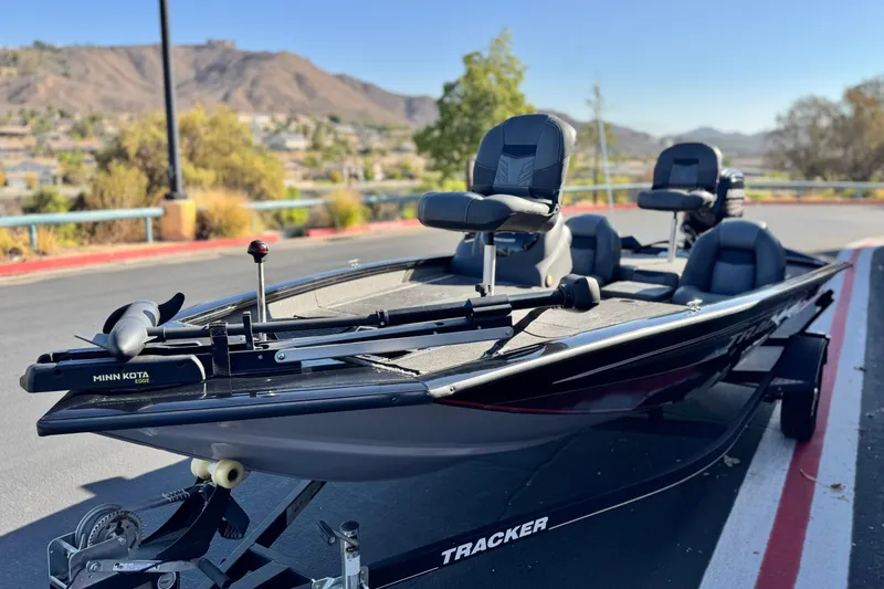 Slide: The Image of 2019 Tracker Pro Team 175 boat with Minn Kota motor, parked outdoors. - 3