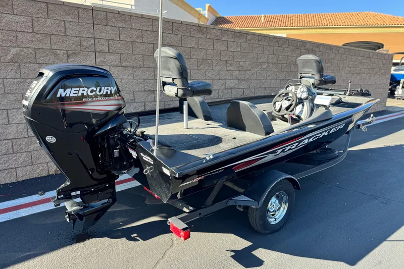 Slide: The Image of 2019 Tracker Pro Team 175 boat with Mercury engine, parked outdoors. - 5