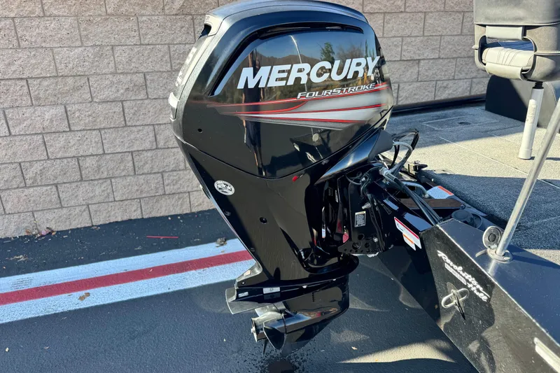 Slide: The Image of 2019 Tracker Pro Team 175 with Mercury FourStroke outboard motor, parked on pavement. - 6