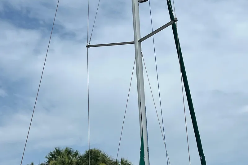 Slide: The Image of 2007 Beneteau Oceanis 46 sailboat with tall mast against cloudy sky. - 11