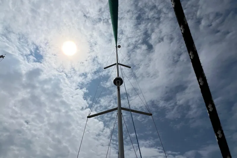 Slide: The Image of Mast of 2007 Beneteau Oceanis 46 sailboat against cloudy sky and sun. - 12