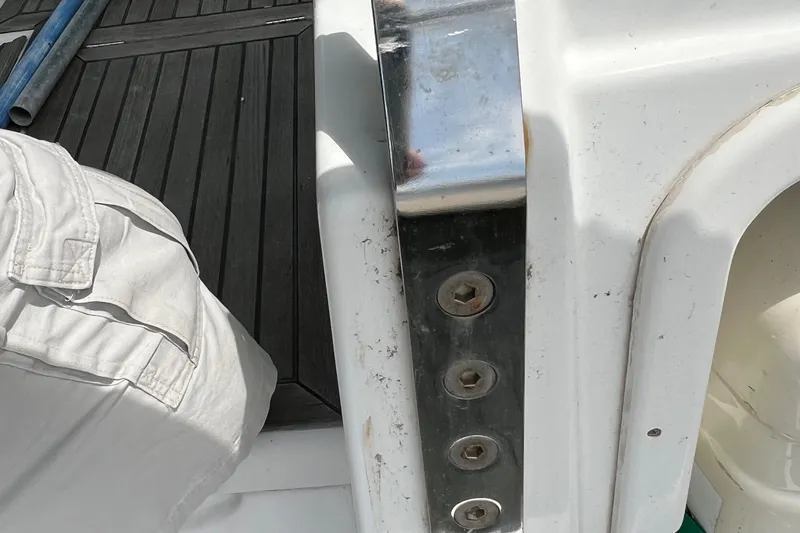 Slide: The Image of Close-up of Beneteau Oceanis 46 yacht deck, featuring metal fittings and white surface, 2007 model. - 16