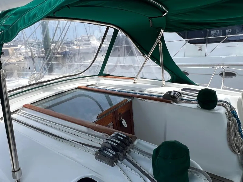 Slide: The Image of 2007 Beneteau Oceanis 46 cockpit with green canopy and visible rigging. - 19