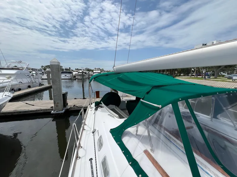 Slide: The Image of Beneteau Oceanis 46 sailboat, 2007 model, docked with green canopy, marina background. - 29