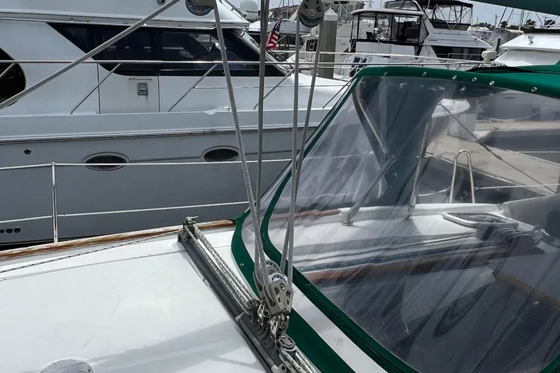 Slide: The Image of Beneteau Oceanis 46 sailboat, 2007 model, docked with other boats in a marina. - 30
