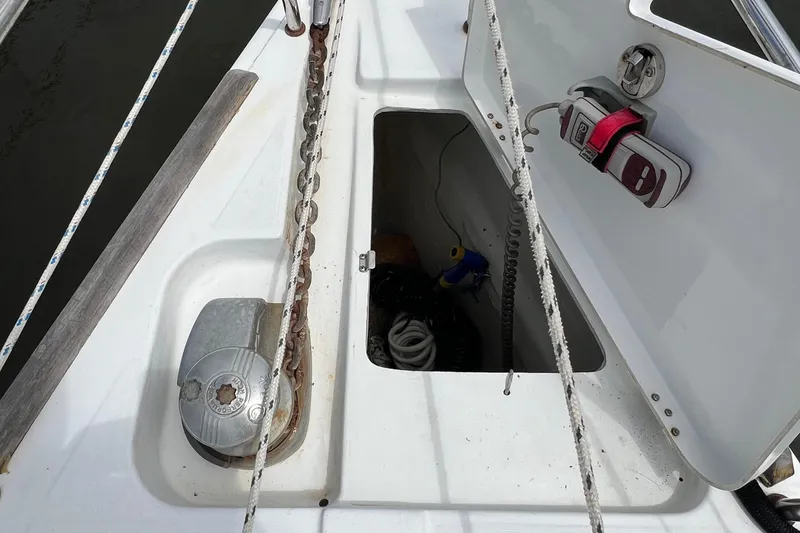 Slide: The Image of Anchor locker of 2007 Beneteau Oceanis 46 sailboat with open hatch and visible equipment. - 33