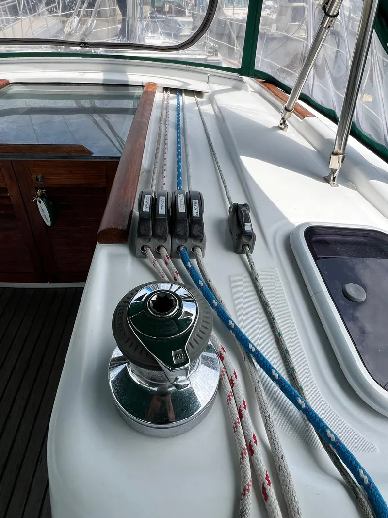 Slide: The Image of 2007 Beneteau Oceanis 46 sailboat deck with winch and rope clutches. - 38