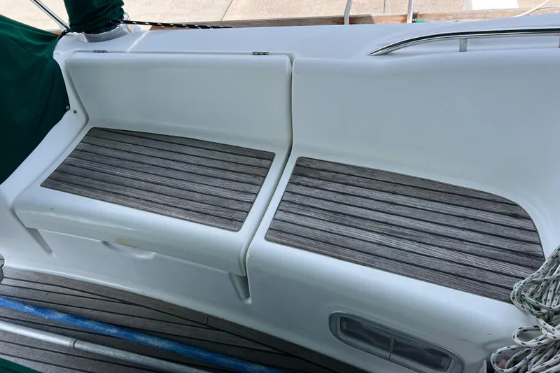 Slide: The Image of Beneteau Oceanis 46 (2007) cockpit seating with wooden slats and white trim. - 40