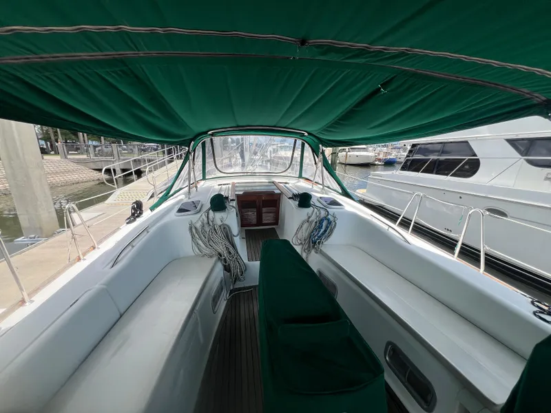 Slide: The Image of 2007 Beneteau Oceanis 46 sailboat cockpit with green canopy, docked at marina. - 45