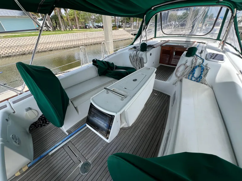 Slide: The Image of 2007 Beneteau Oceanis 46 sailboat cockpit with green canopy and seating. - 46
