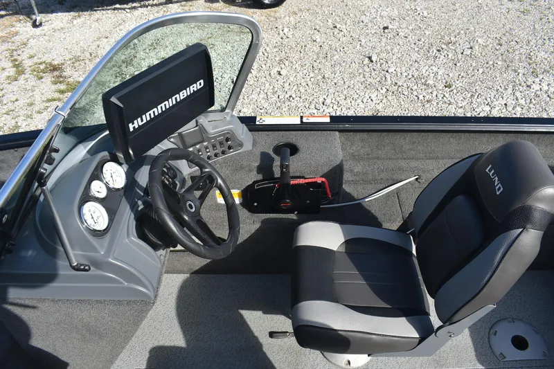 Slide: The Image of 2014 Lund 1650 Rebel XL Sport boat interior with steering wheel, gauges, and Humminbird display. - 10