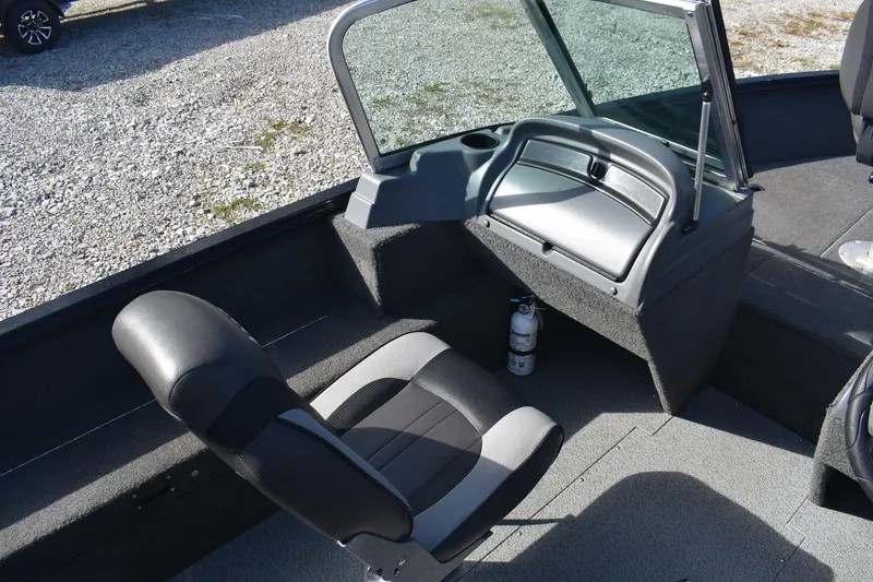 Slide: The Image of 2014 Lund 1650 Rebel XL Sport boat interior with seating and windshield. - 12