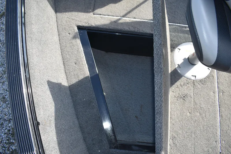 Slide: The Image of 2014 Lund 1650 Rebel XL Sport boat interior with open storage compartment. - 14