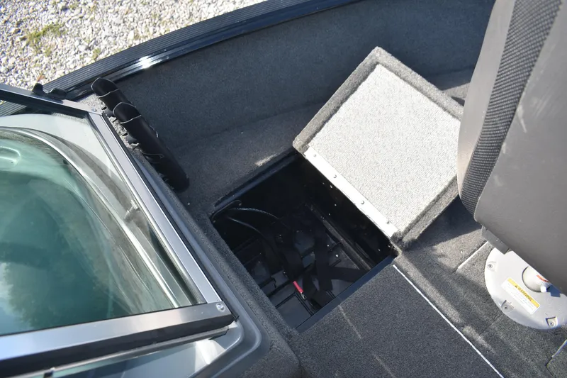Slide: The Image of 2014 Lund 1650 Rebel XL Sport boat interior with open storage compartment. - 15