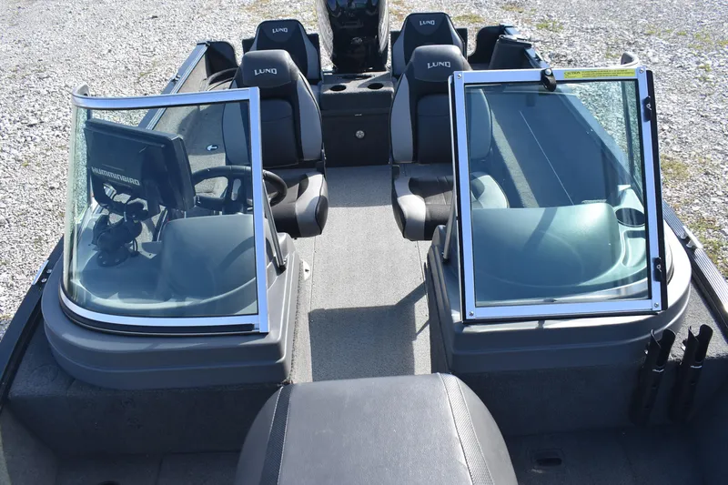 Slide: The Image of 2014 Lund 1650 Rebel XL Sport boat interior with dual consoles and seating. - 18