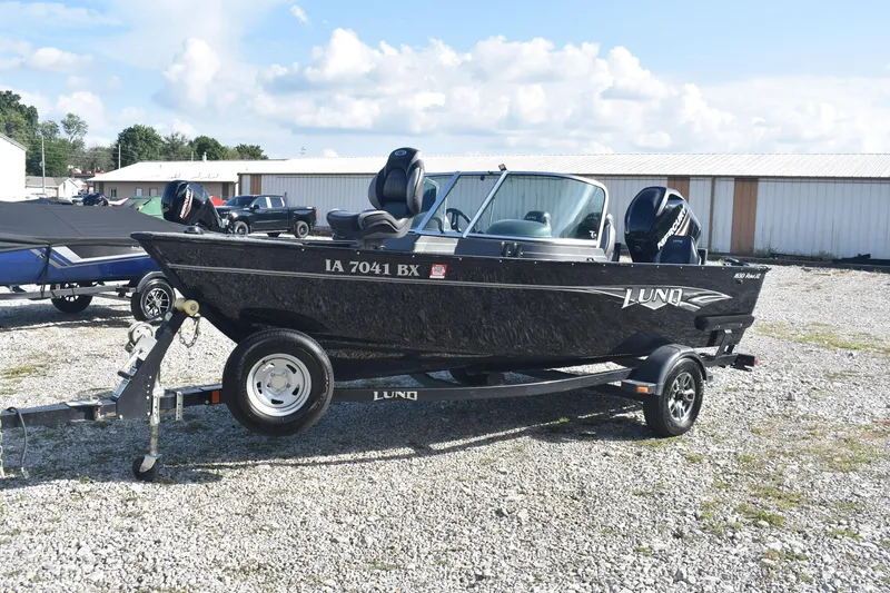 Slide: The Image of 2014 Lund 1650 Rebel XL Sport boat on trailer, parked outdoors. - 3