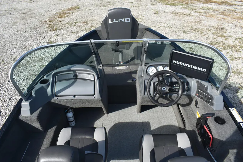 Slide: The Image of 2014 Lund 1650 Rebel XL Sport boat interior with steering wheel and Humminbird display. - 9