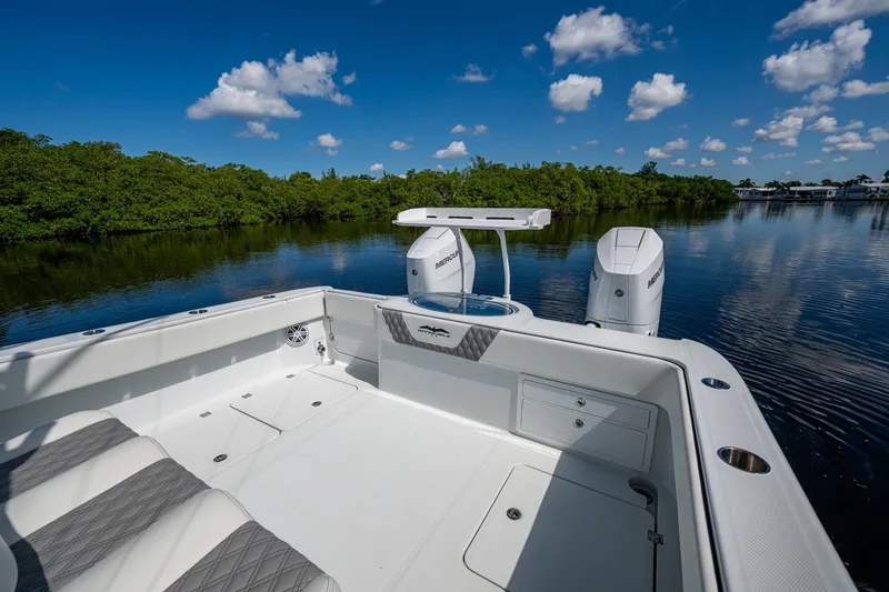 Slide: The Image of 2025 Invincible 33 Catamaran on calm water, featuring sleek design and powerful engines. - 12