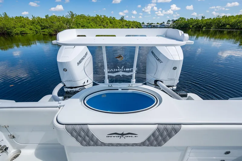 Slide: The Image of 2025 Invincible 33 Catamaran with dual Mercury engines on a serene water backdrop. - 14