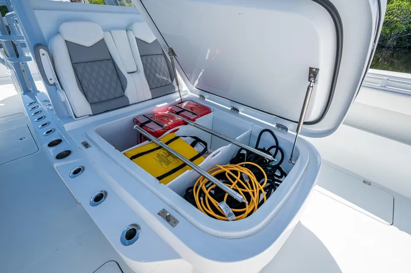 Slide: The Image of Storage compartment of 2025 Invincible 33 Catamaran with safety equipment and cables. - 18