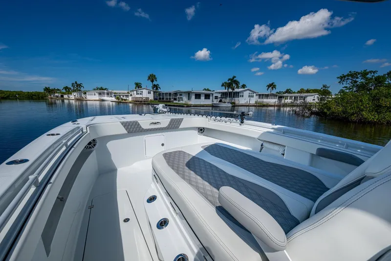 Slide: The Image of 2025 Invincible 33 Catamaran on calm water, showcasing luxurious seating and modern design. - 22