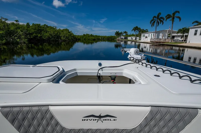 Slide: The Image of 2025 Invincible 33 Catamaran on tranquil waterway, showcasing sleek design and luxury features. - 23