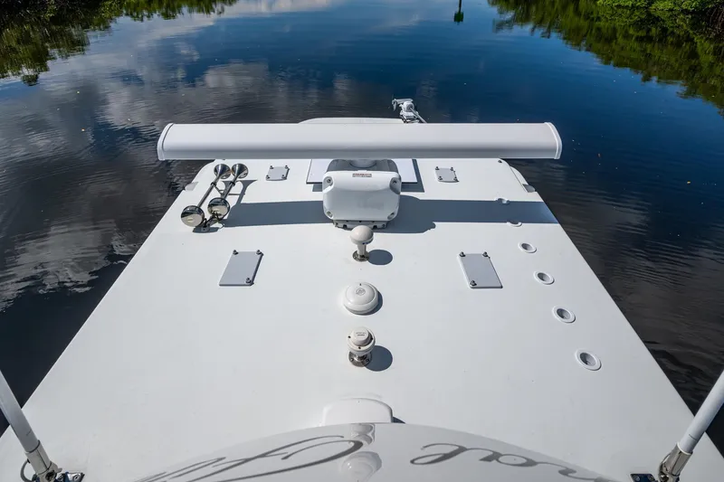 Slide: The Image of 2025 Invincible 33 Catamaran deck view on calm water, showcasing sleek design and equipment. - 29