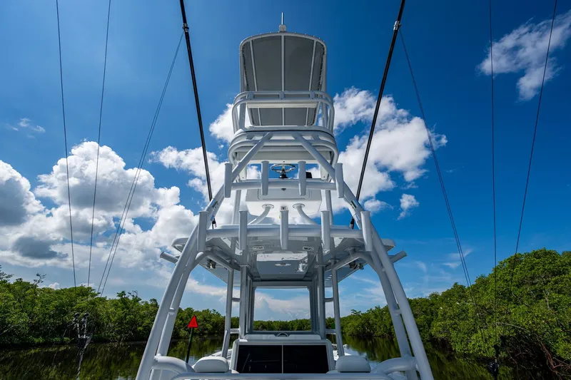 Slide: The Image of 2025 Invincible 33 Catamaran tower against blue sky and lush greenery. - 30