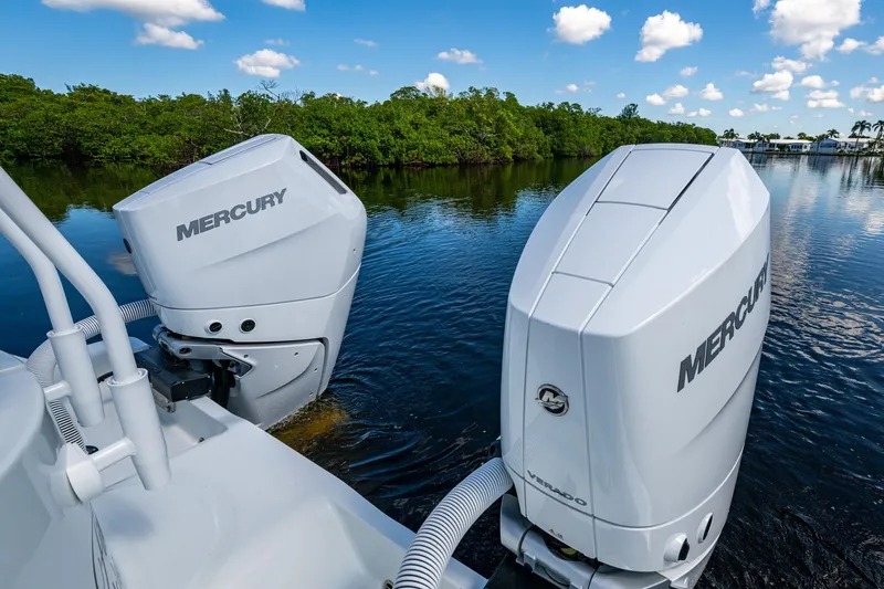 Slide: The Image of Twin Mercury outboard engines on 2025 Invincible 33 Catamaran, cruising in scenic waters. - 32