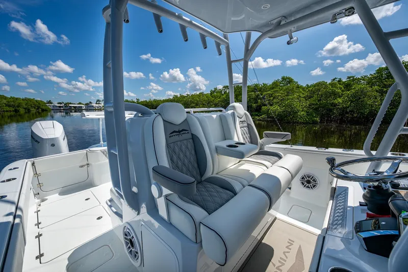 Slide: The Image of 2025 Invincible 33 Catamaran interior with luxurious seating and scenic waterway view. - 8