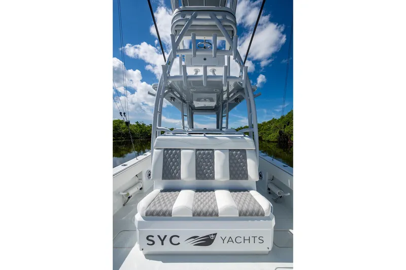 Slide: The Image of 2025 Invincible 33 Catamaran with luxurious seating and sleek design under a clear sky. - 9