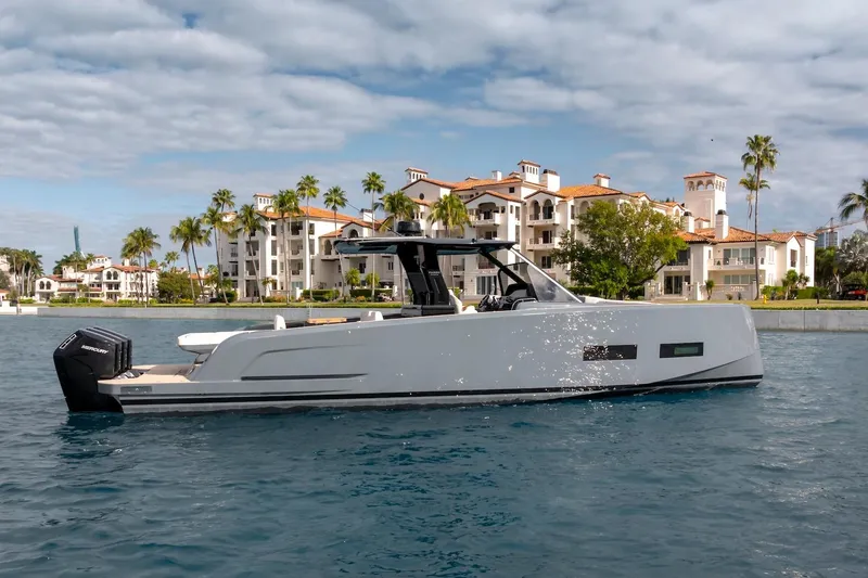 Slide: The Image of 2026 Pardo Yachts P43R cruising near luxury waterfront residences. - 27