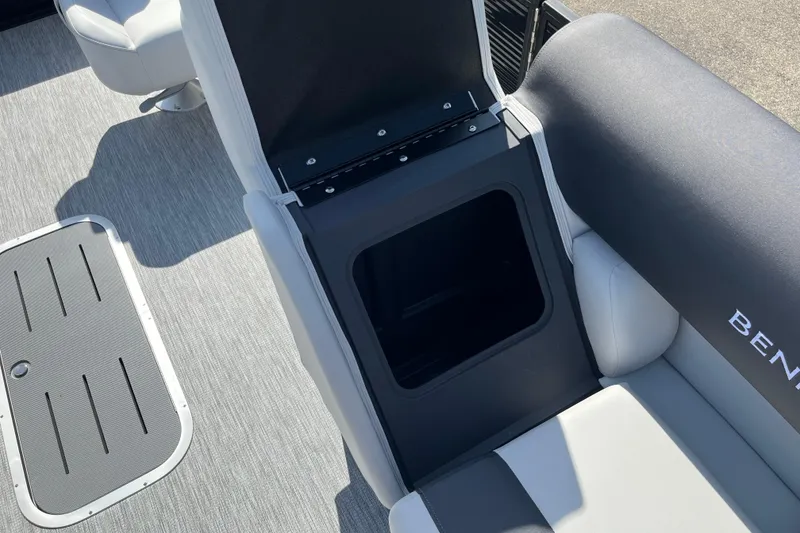 Slide: The Image of 2026 Bennington S Line boat interior with open storage compartment and cushioned seating. - 11