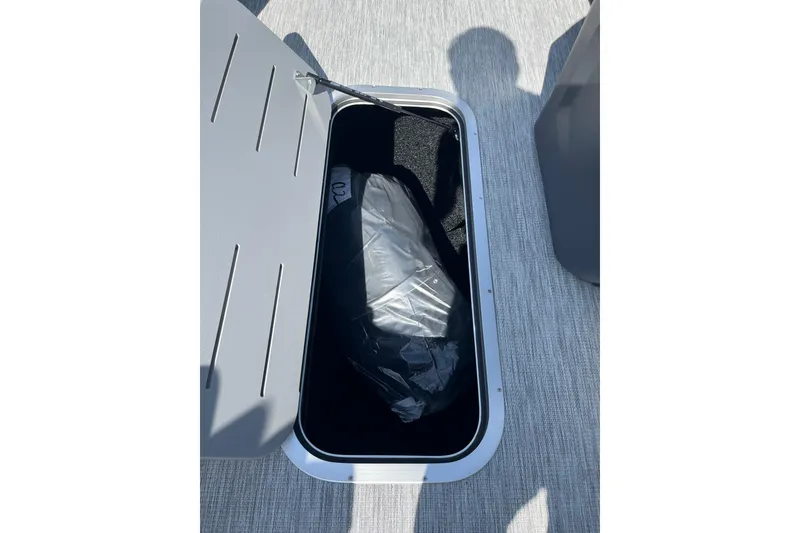 Slide: The Image of Open storage compartment on 2026 Bennington S Line boat, showing interior details. - 13