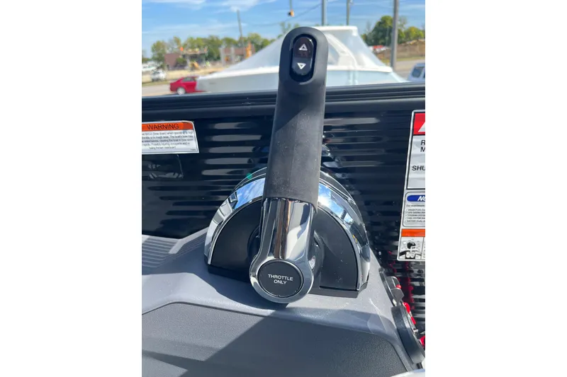 Slide: The Image of Throttle control of 2026 Bennington S Line boat, featuring warning labels and sleek design. - 16