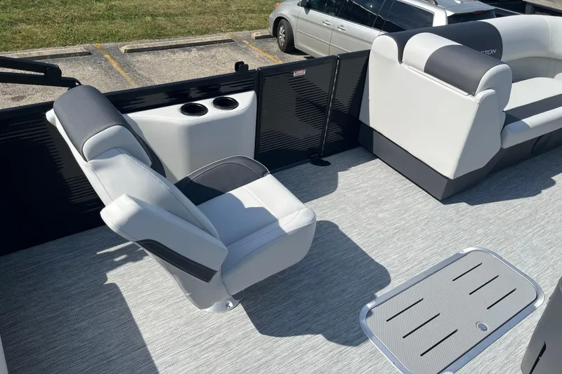 Slide: The Image of 2026 Bennington S Line boat interior with gray seating and cup holders. - 4