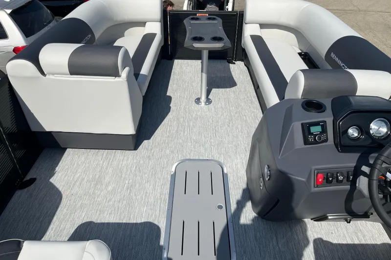 Slide: The Image of 2026 Bennington S Line boat interior with gray seating and modern dashboard. - 6