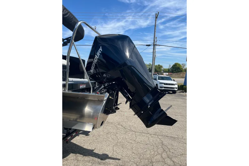 Slide: The Image of 2026 Bennington S Line boat with Mercury outboard motor in a parking lot. - 8