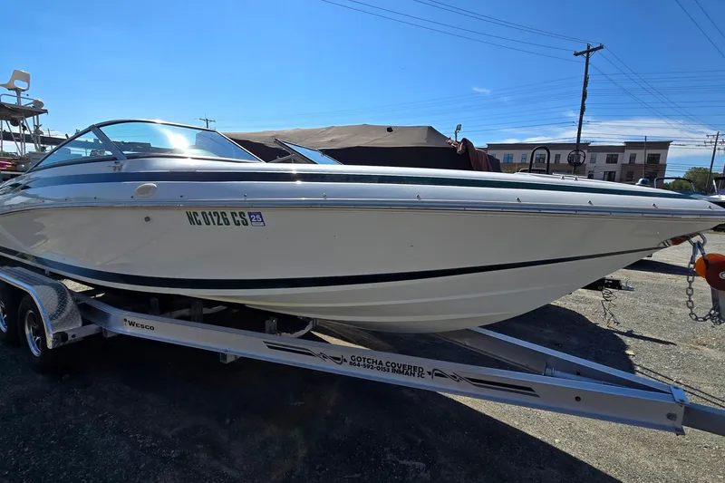 Slide: The Image of 1996 Cobalt 220 boat on trailer under clear blue sky. - 0