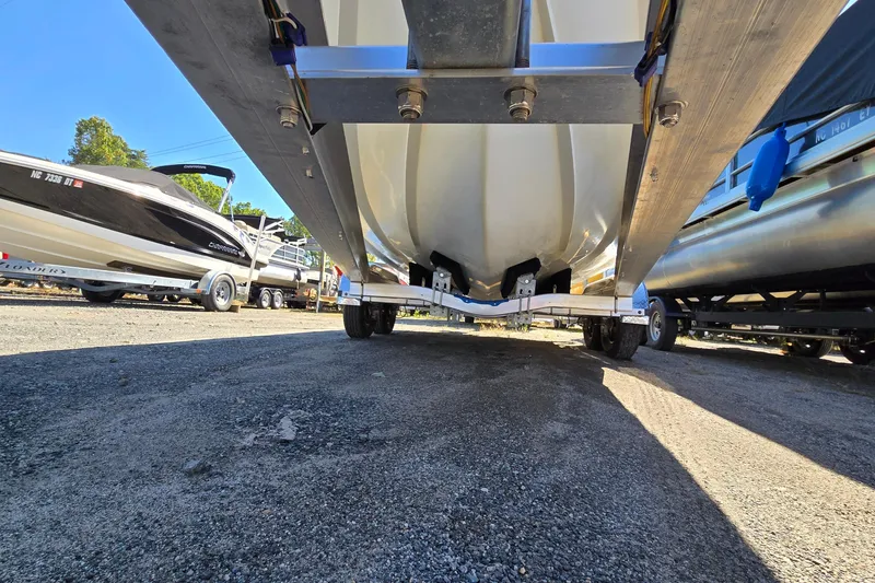 Slide: The Image of Underneath view of a 1996 Cobalt 220 boat on a trailer in a parking area. - 11
