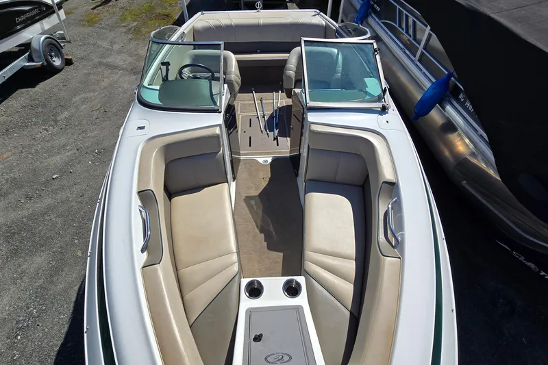 Slide: The Image of 1996 Cobalt 220 boat interior with beige seating and open deck layout. - 13