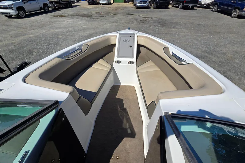 Slide: The Image of 1996 Cobalt 220 boat interior with beige seating and open bow design. - 15