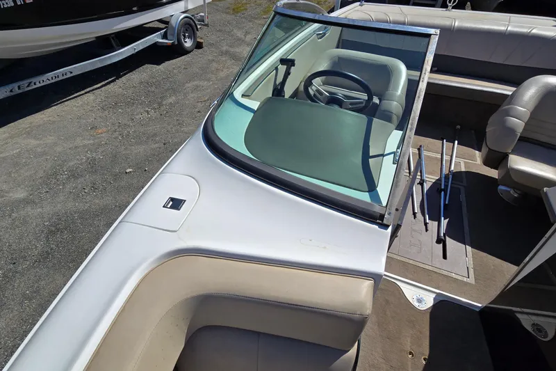 Slide: The Image of Interior view of a 1996 Cobalt 220 boat, featuring steering wheel and seating. - 16