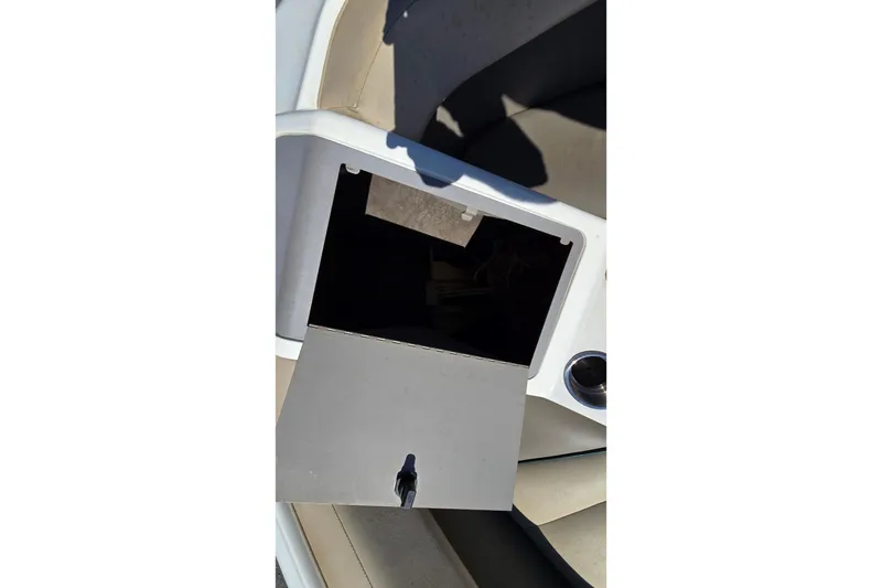 Slide: The Image of Open storage compartment on a 1996 Cobalt 220 boat, showing interior details. - 18